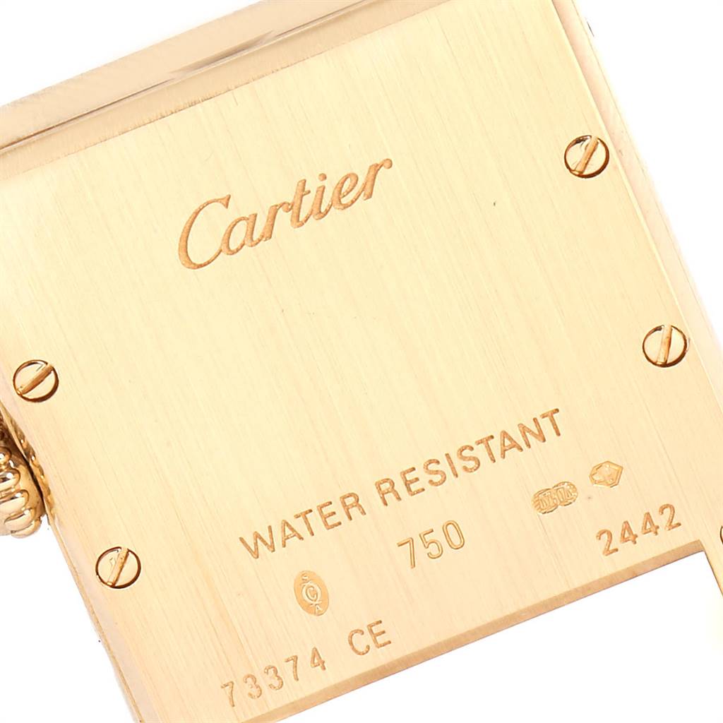 This image shows the back case of the Tank Louis watch by Cartier, featuring the brand
s logo and various engravings.