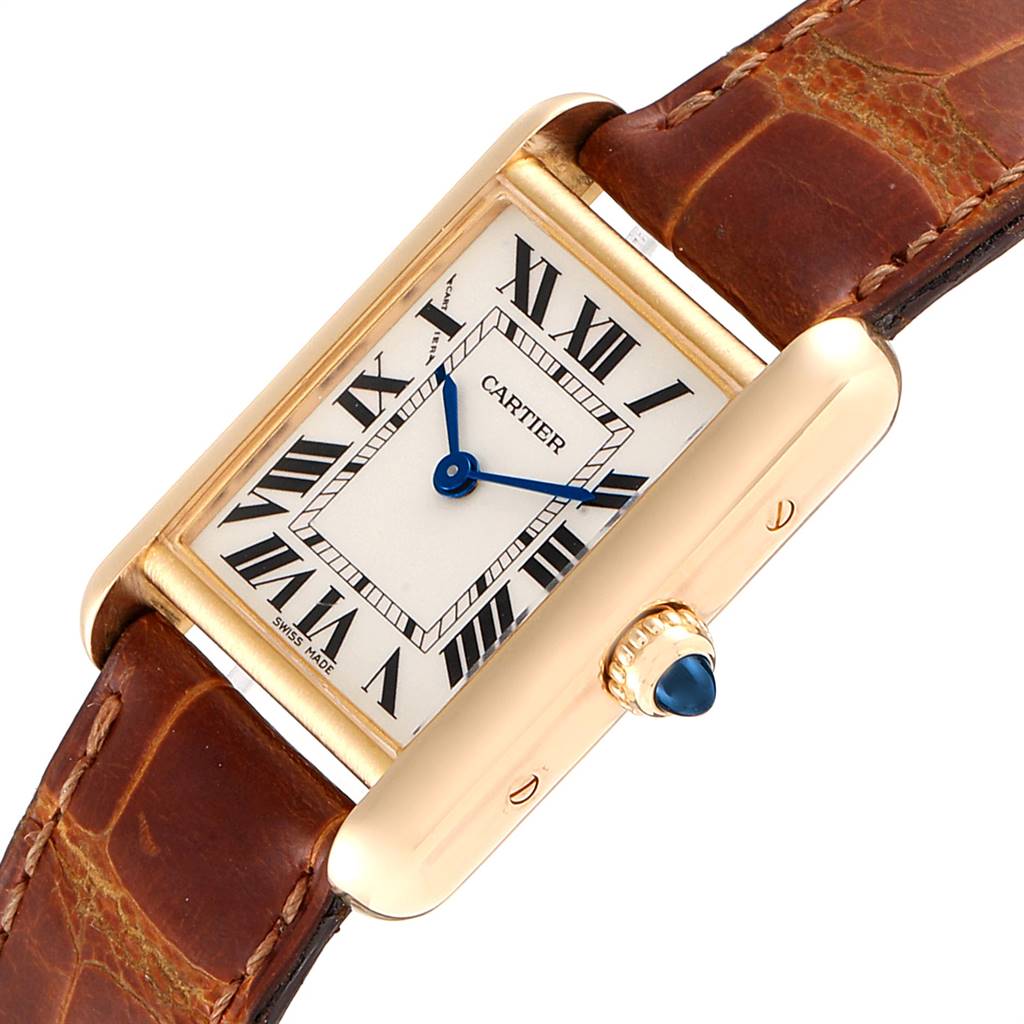 This is a close-up view of a Cartier Tank Louis W1529856 Women
s Yellow Gold Silver Dial W1529856 Women
s Yellow Gold Silver Dial watch, showing the face, Roman numerals, blue hands, crown, and leather strap.