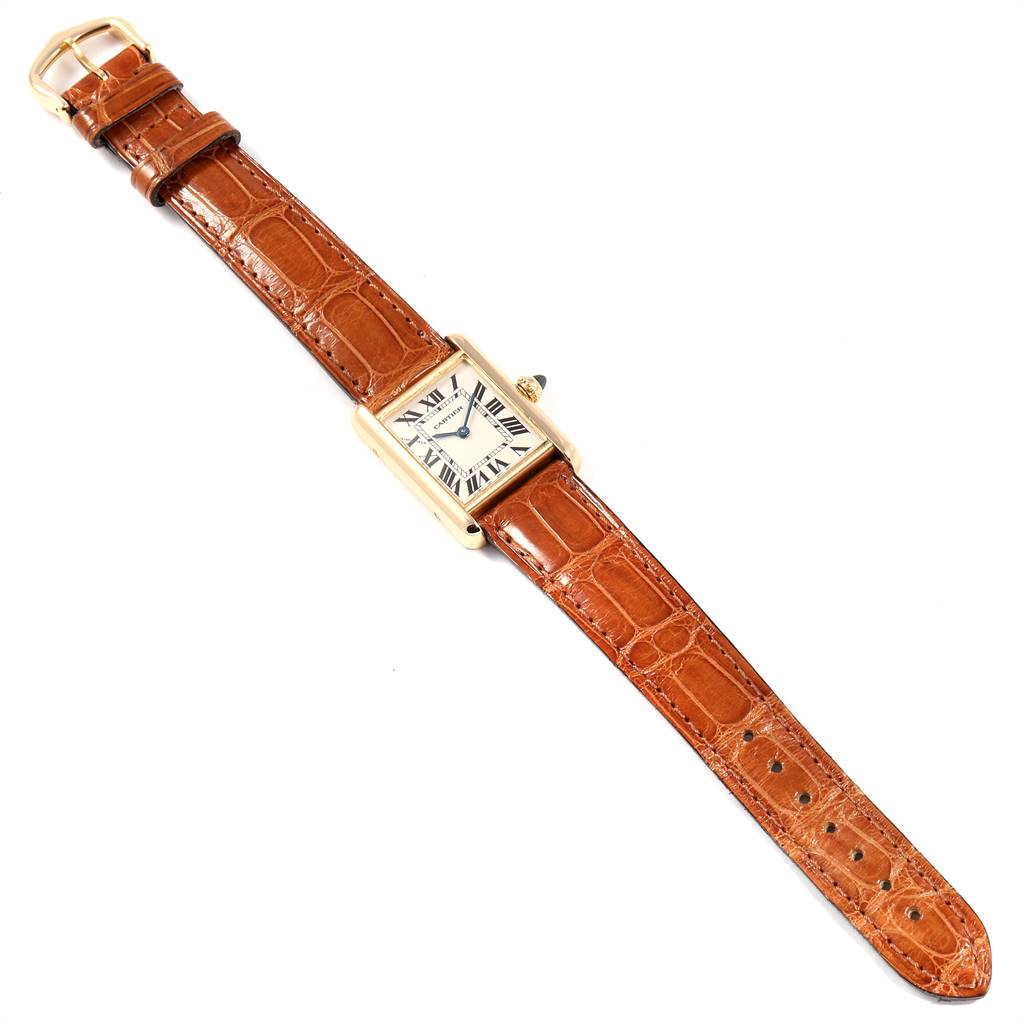 The image shows a top-down view of a Cartier Tank Louis W1529856 Women
s Yellow Gold Silver Dial W1529856 Women
s Yellow Gold Silver Dial watch, displaying its rectangular face and brown leather strap.