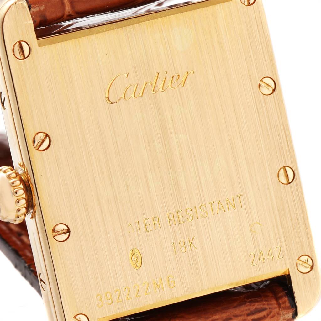 The image shows the back case, crown, and part of the strap of a Cartier Tank Louis W1529856 Women
s Yellow Gold Silver Dial W1529856 Women
s Yellow Gold Silver Dial watch.