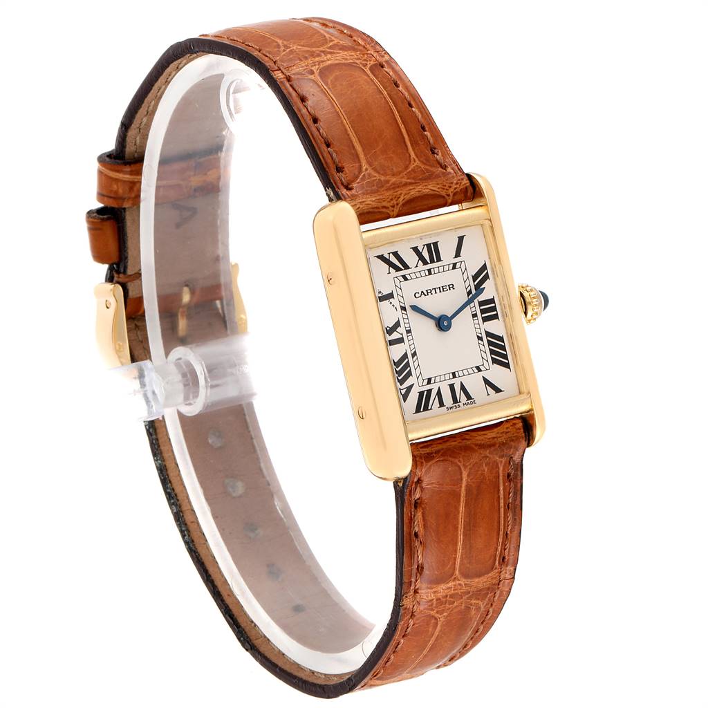 The image shows a Tank Louis Cartier watch angled to display the face, brown leather strap, and gold casing with a side view of the crown.