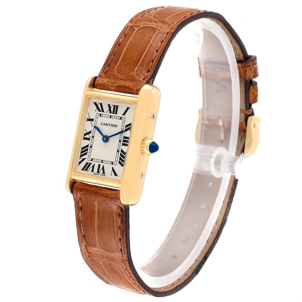 The Cartier Tank Louis W1529856 Women
s Yellow Gold Silver Dial W1529856 Women
s Yellow Gold Silver Dial watch is shown at a slight angle, displaying its face, leather strap, and gold casing.