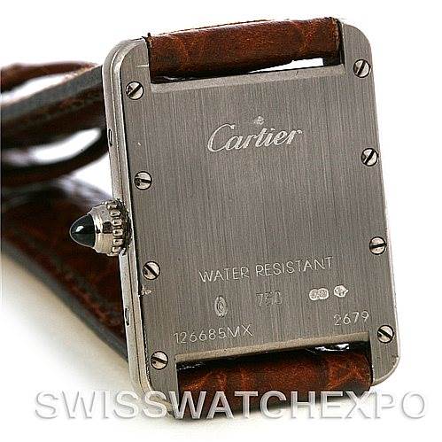 This image shows the back case of a Cartier Tank Louis W1541056 Women's White Gold Silver Dial W1541056 Women's White Gold Silver Dial watch, featuring details like screws, brand engraving, and the brown leather strap ends.