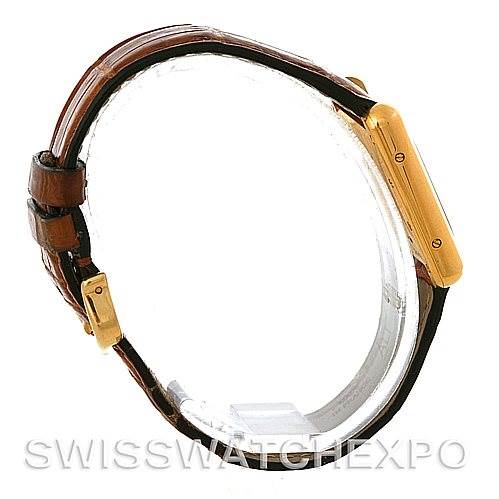 The image shows a side and strap view of the Tank Louis model by Cartier, featuring a brown leather strap and gold case.