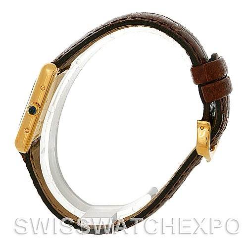 The photo shows a side view of a Cartier Tank Louis W1529856 Women's Yellow Gold Silver Dial W1529856 Women's Yellow Gold Silver Dial watch displaying its gold case, crown, and brown leather strap.