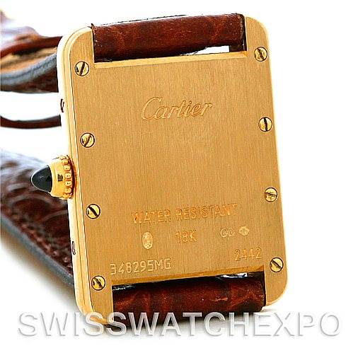 This image shows the back of a Cartier Tank Louis W1529856 Women's Yellow Gold Silver Dial W1529856 Women's Yellow Gold Silver Dial watch with its leather strap and gold casing.