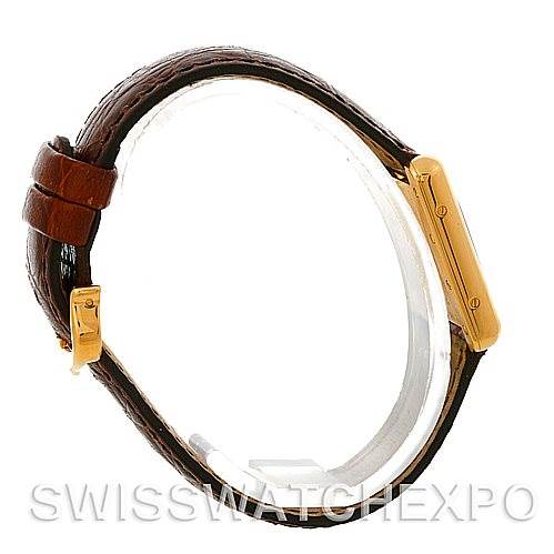 The photo shows a side view of the Cartier Tank Louis W1529856 Women's Yellow Gold Silver Dial W1529856 Women's Yellow Gold Silver Dial model watch, highlighting the brown leather strap and gold rectangular case.