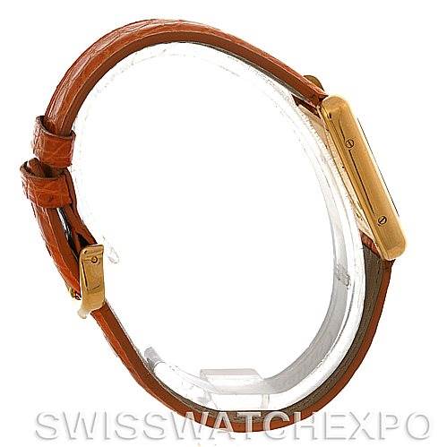 The image shows a side view of the Cartier Tank Louis W1529856 Women's Yellow Gold Silver Dial W1529856 Women's Yellow Gold Silver Dial watch, highlighting its brown leather strap and slim gold case.