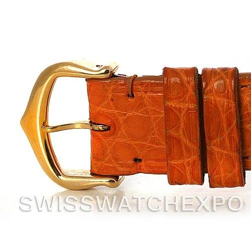 This image shows a close-up of the leather strap and gold buckle from a Tank Louis Cartier watch.