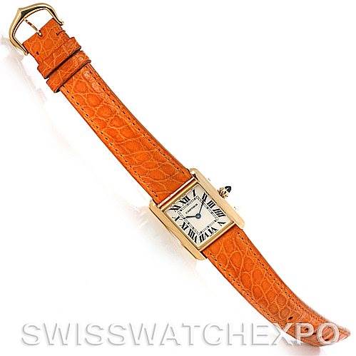 This image shows a Cartier Tank Louis W1529856 Women's Yellow Gold Silver Dial W1529856 Women's Yellow Gold Silver Dial watch with an orange leather strap, viewed from a top-down angle.