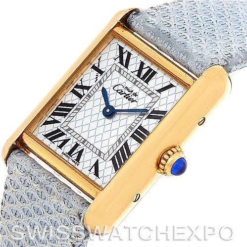 This image showcases the Cartier Tank Louis 2415 Women's Yellow Gold Blue Dial 2415 Women's Yellow Gold Blue Dial model watch at a tilted angle, highlighting its dial, Roman numerals, and blue gemstone crown.
