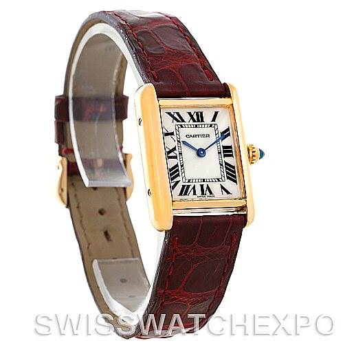 The image shows a Tank Louis model by Cartier at a slight angle, highlighting the watch face, gold casing, and brown leather strap.