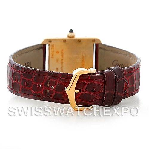 This image shows the back of a Cartier Tank Louis W1529856 Women's Yellow Gold Silver Dial W1529856 Women's Yellow Gold Silver Dial watch, focusing on the gold clasp and textured red leather strap.
