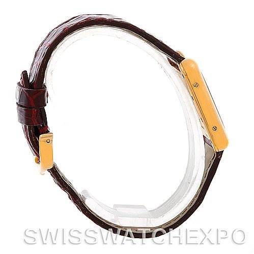 This image shows a Cartier Tank Louis W1529856 Women's Yellow Gold Silver Dial W1529856 Women's Yellow Gold Silver Dial watch in a side profile, highlighting its gold case and brown leather strap.