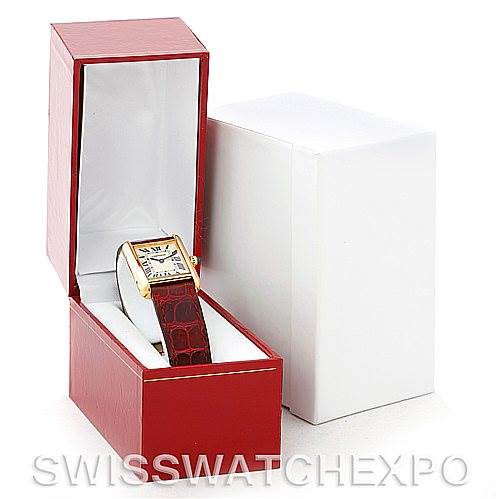 The image shows a Cartier Tank Louis W1529856 Women's Yellow Gold Silver Dial W1529856 Women's Yellow Gold Silver Dial watch angled inside an open red box revealing the face and the strap.