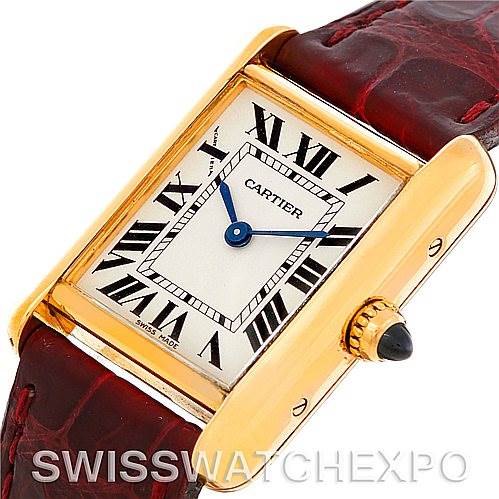 The image shows a close-up of the Cartier Tank Louis W1529856 Women's Yellow Gold Silver Dial W1529856 Women's Yellow Gold Silver Dial watch face, highlighting its gold case, Roman numerals, and red leather strap from an angled side view.