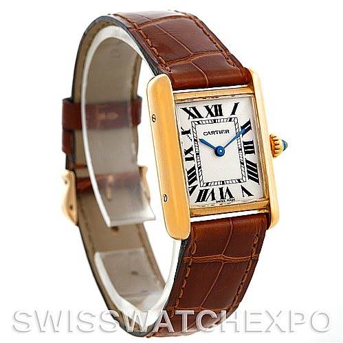 This image shows a Tank Louis Cartier watch at a slight side angle, highlighting its gold rectangular case, brown leather strap, and Roman numeral dial.