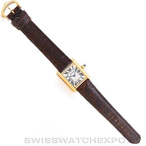 The image shows a Tank Louis model by Cartier, viewed from above, displaying the entire watch with a brown leather strap and rectangular gold case.