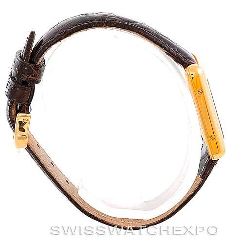 Side view of the Cartier Tank Louis W1529856 Women's Yellow Gold Silver Dial W1529856 Women's Yellow Gold Silver Dial watch showing the brown leather strap and gold case.