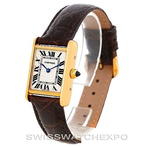The image shows a Cartier Tank Louis W1529856 Women's Yellow Gold Silver Dial W1529856 Women's Yellow Gold Silver Dial watch at an angle highlighting the gold case, leather strap, and Roman numeral dial.