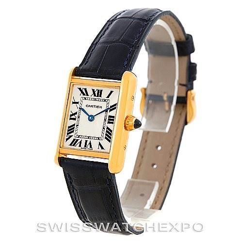 The image shows a Cartier Tank Louis W1529856 Women's Yellow Gold Silver Dial W1529856 Women's Yellow Gold Silver Dial model watch at an angle displaying its rectangular face, Roman numeral markers, blue hands, and leather strap.