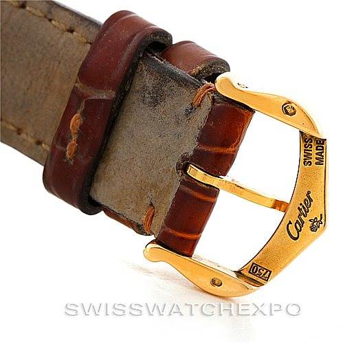 This is a close-up of the clasp and part of the leather strap of a Cartier Tank Louis W1529856 Women's Yellow Gold Silver Dial W1529856 Women's Yellow Gold Silver Dial watch.