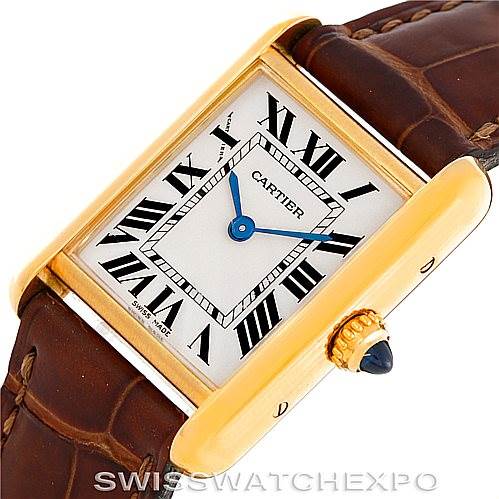The image shows the Cartier Tank Louis W1529856 Women's Yellow Gold Silver Dial W1529856 Women's Yellow Gold Silver Dial model watch at a tilted angle, highlighting the dial, Roman numerals, and crown with a blue cabochon.