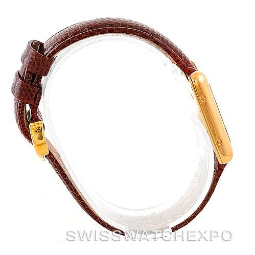 The image shows a Cartier Tank Louis W1529856 Women's Yellow Gold Silver Dial W1529856 Women's Yellow Gold Silver Dial watch from a side/top angle, highlighting its brown leather strap and gold case.