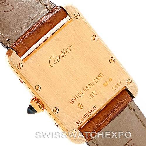 The image shows the back case and part of the leather strap of a Tank Louis model by Cartier.
