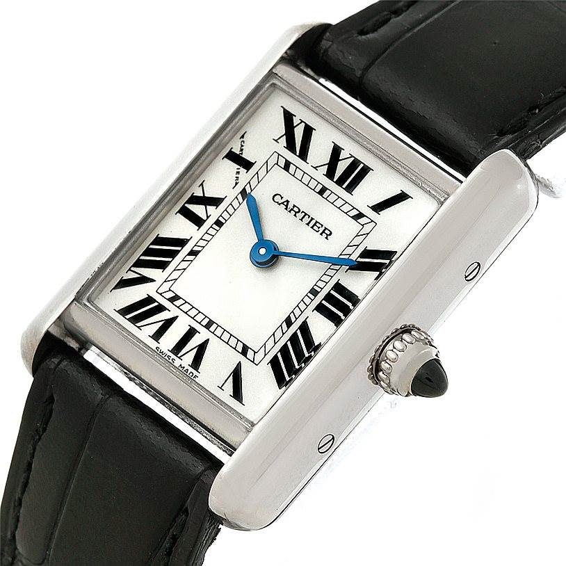 The image shows a Cartier Tank Louis W1541056 Women's White Gold Silver Dial W1541056 Women's White Gold Silver Dial watch from a slight angled view, highlighting its dial, crown, and part of its leather strap.