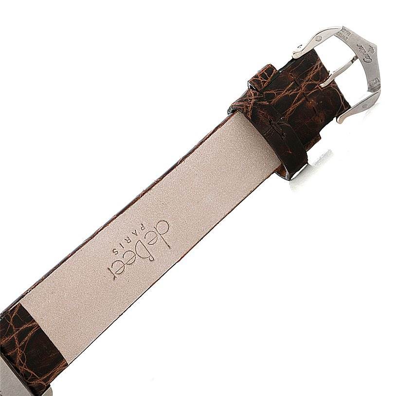 The image shows a close-up of the strap and buckle of a Tank Louis model watch by Cartier.