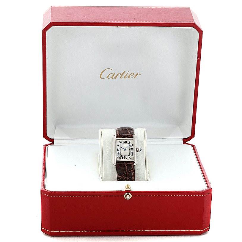 The Tank Louis Cartier watch is shown front-facing inside an open, red Cartier box.