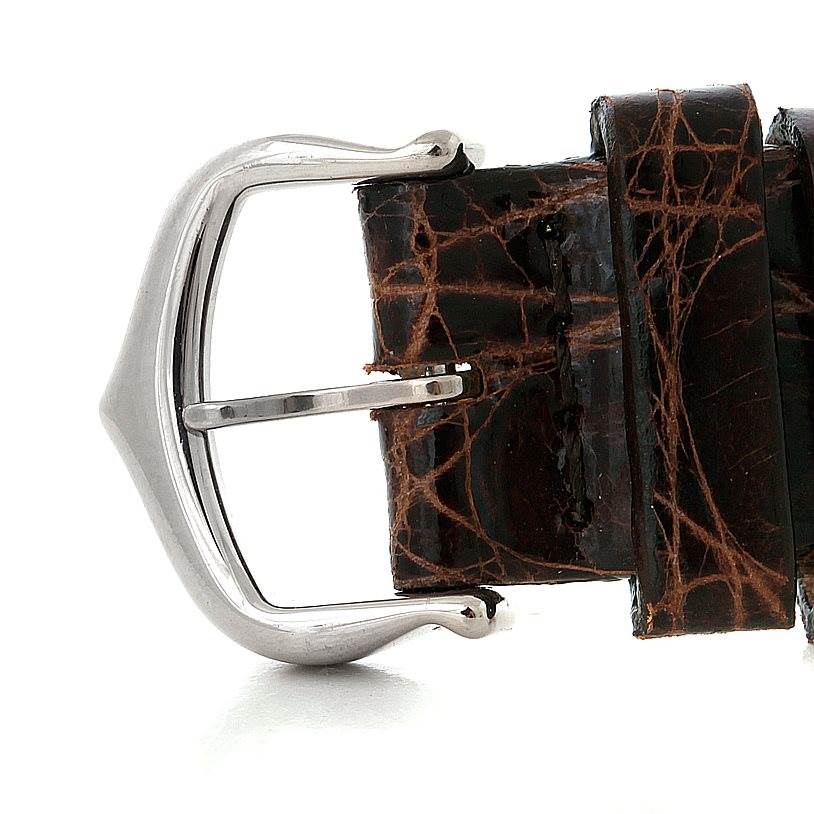 The image shows a close-up of the buckle and strap of a Tank Louis watch by Cartier, highlighting its details.