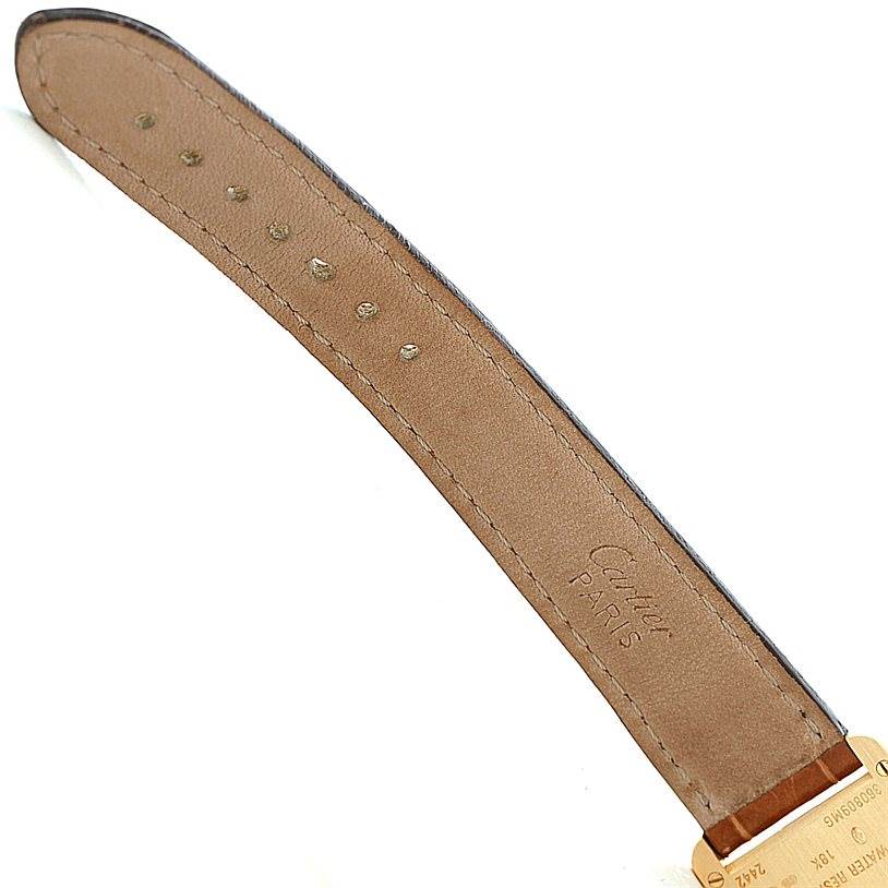 This image shows the backside of the leather strap of a Tank Louis model by Cartier, displaying holes and branding.