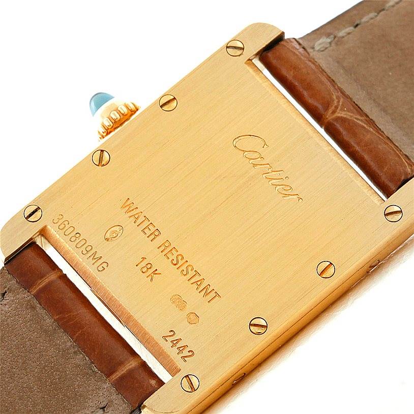 This image shows the back of the Tank Louis model watch by Cartier, highlighting the gold case and part of the leather strap.