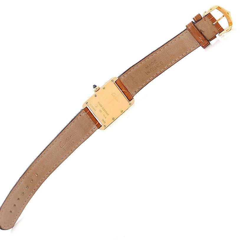 The image shows the back side of a Tank Louis watch by Cartier, including the case back, leather strap, and buckle.