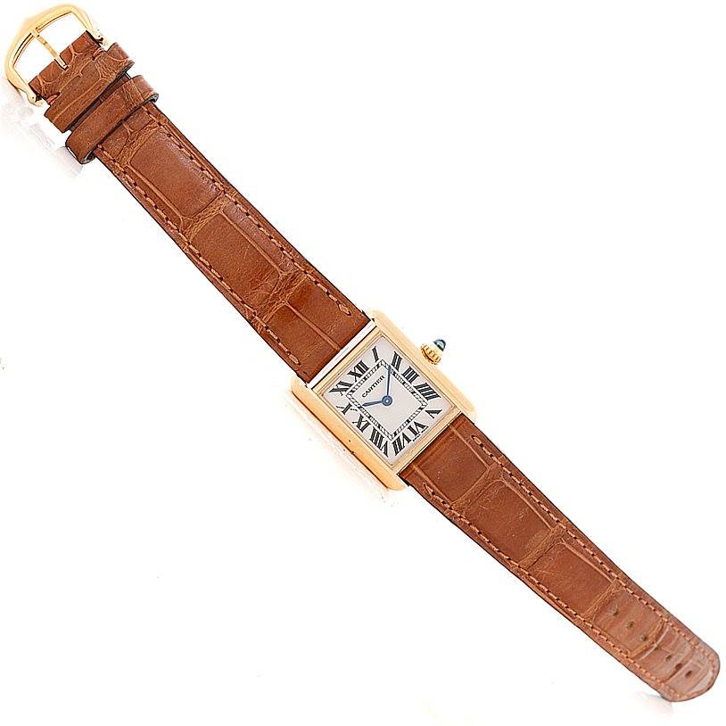 The image shows a top-down view of a Cartier Tank Louis W1529856 Women's Yellow Gold Silver Dial W1529856 Women's Yellow Gold Silver Dial watch with a rectangular face and brown leather strap.