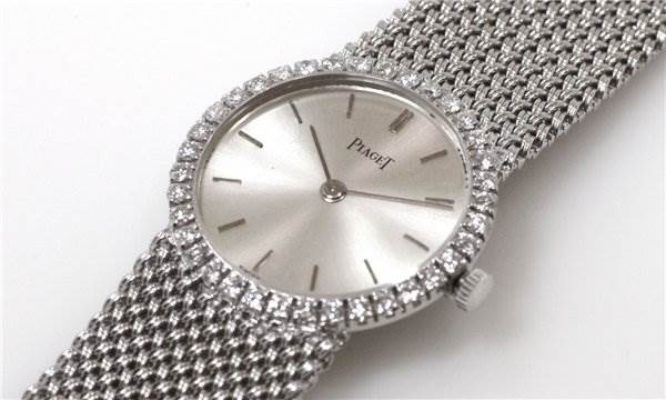 The watch is shown from a top-down angle, displaying the dial, diamond-set bezel, and metal band of the Piaget 926/D/21 Women's White Gold Silver Dial 926/D/21 Women's White Gold Silver Dial Vintage Ladies 18k White Gold Diamond Watch.