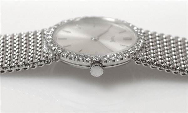 This image shows a side view of the Piaget 926/D/21 Women's White Gold Silver Dial 926/D/21 Women's White Gold Silver Dial Vintage Ladies 18k White Gold Diamond Watch, highlighting the crown and diamond-set bezel.