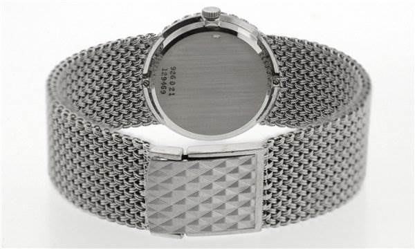 The image shows the back view of a Piaget 926/D/21 Women's White Gold Silver Dial 926/D/21 Women's White Gold Silver Dial Vintage Ladies 18k White Gold Diamond Watch, highlighting the case back, crown, and mesh bracelet.