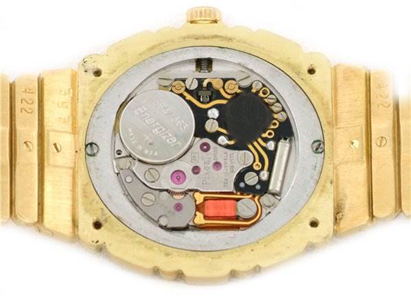 The image shows the back view of the Piaget 861C701 Women
s Yellow Gold Champagne Dial 861C701 Women
s Yellow Gold Champagne Dial Polo 861c701 Ladies 18k Gold Diamonds watch, revealing its internal movement and battery.