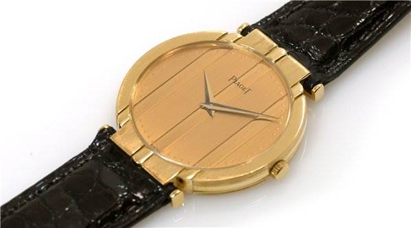 The image shows the front angle of a Piaget 8673 Men's Yellow Gold Champagne Dial 8673 Men's Yellow Gold Champagne Dial Polo 8673 Men's 18k Yellow Gold watch, highlighting the gold case, dial, and black strap.