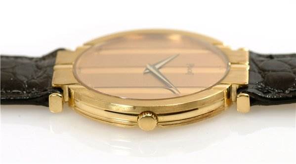 This is a side view of the Piaget 8673 Men's Yellow Gold Champagne Dial 8673 Men's Yellow Gold Champagne Dial Polo 8673 Mens 18k Yellow Gold Watch, showing the case, crown, and part of the strap.