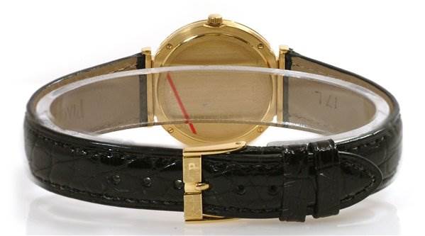 The image shows the back view of the Piaget 8673 Men's Yellow Gold Champagne Dial 8673 Men's Yellow Gold Champagne Dial Polo 8673 men's watch, highlighting its 18k yellow gold case and black leather strap.