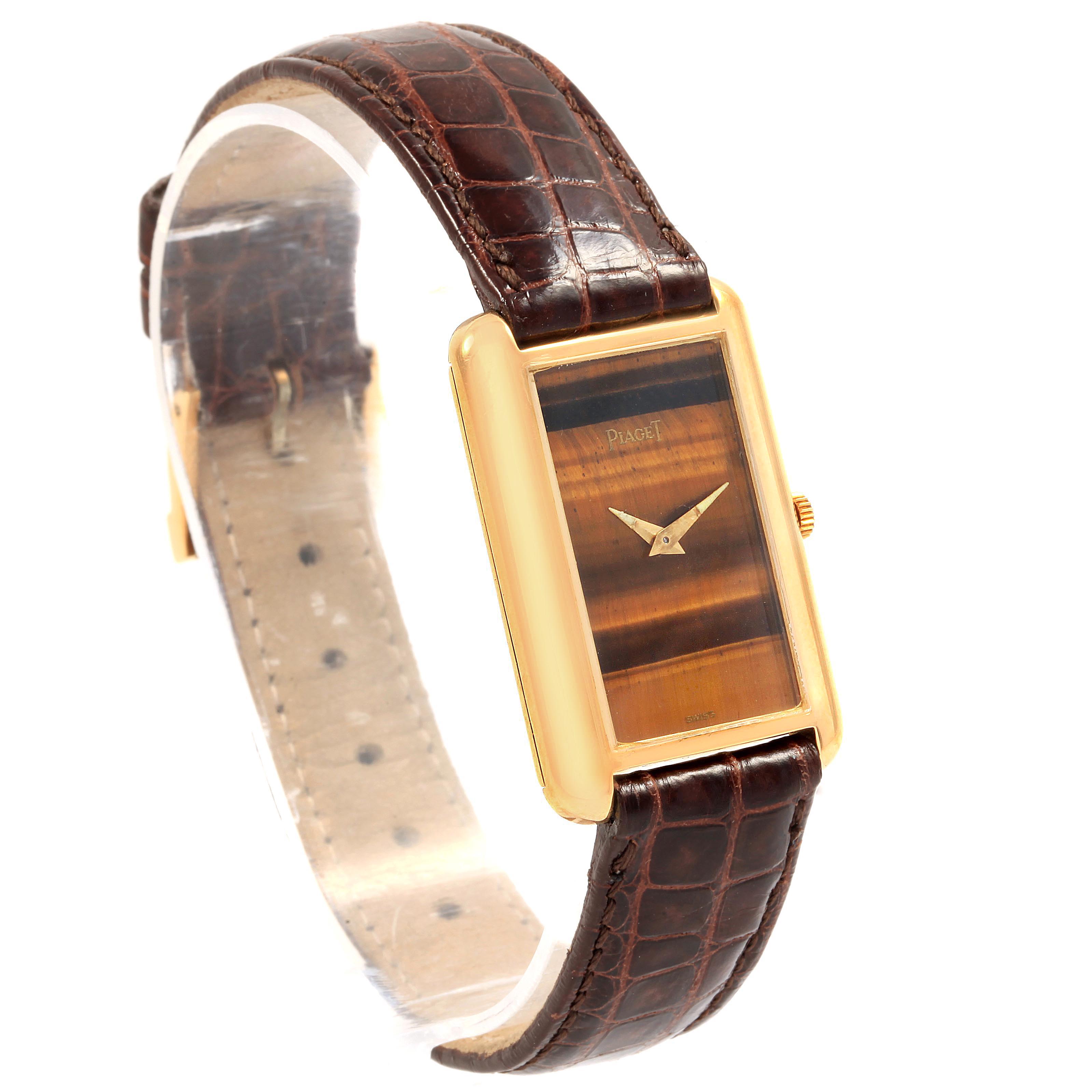 This Piaget 9228 Women's Yellow Gold Brown Dial 9228 Women's Yellow Gold Brown Dial 9228 18K Yellow Gold Tiger Eye Stone Dial Ladies Watch is shown at a three-quarter angle displaying the dial, case, and strap.