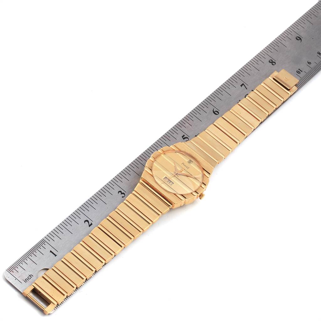 The image shows a top-down view of the Piaget Men's Yellow Gold Champagne Dial Men's Yellow Gold Champagne Dial Polo 18K Yellow Gold Day Date Mens Watch 15562c701 placed next to a ruler for scale.