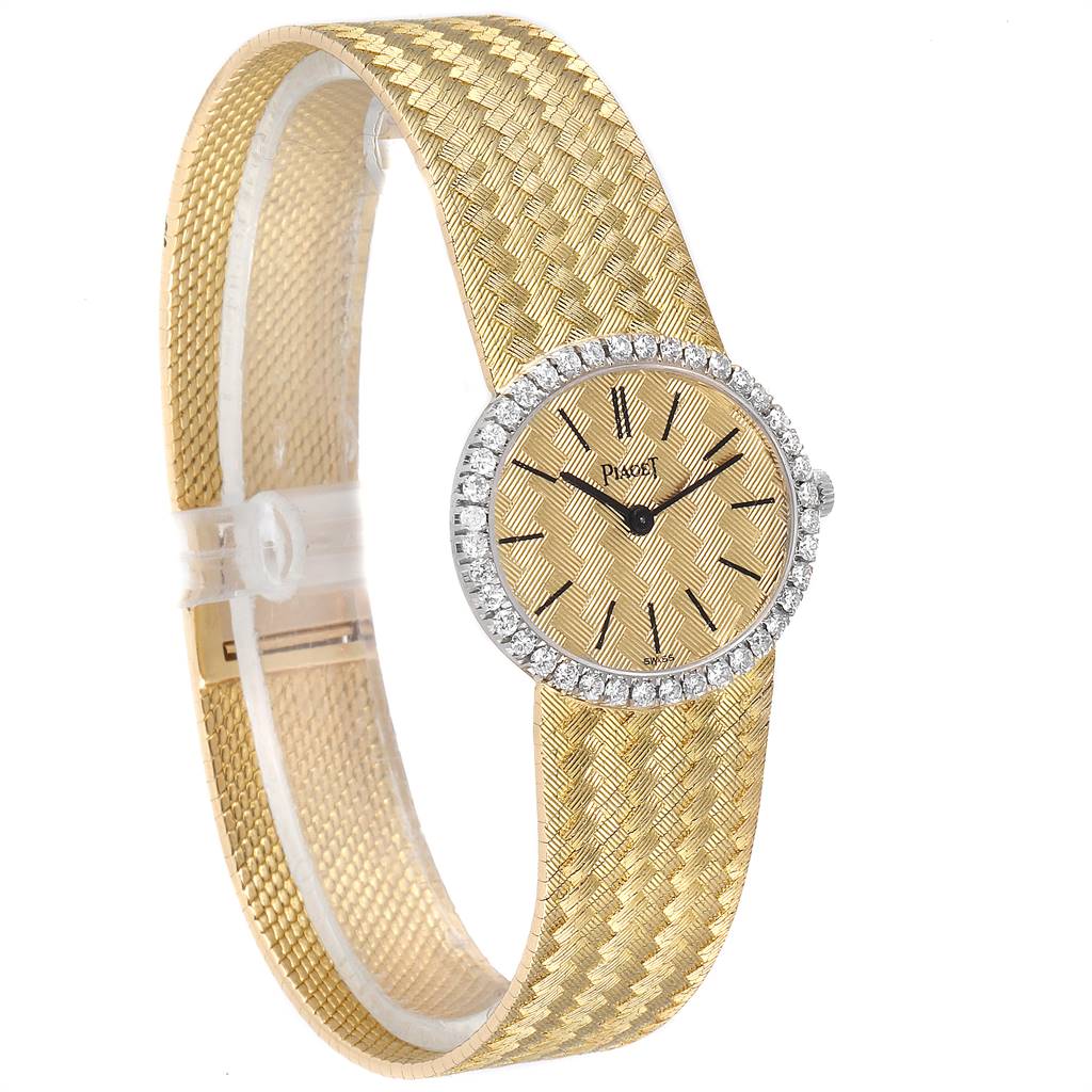 The Piaget 9806 Women
s Yellow Gold Champagne Dial 9806 Women
s Yellow Gold Champagne Dial 9806 18k Yellow Gold Diamond Ladies Watch is shown from a slight side angle, highlighting its textured bracelet and diamond-encrusted bezel.