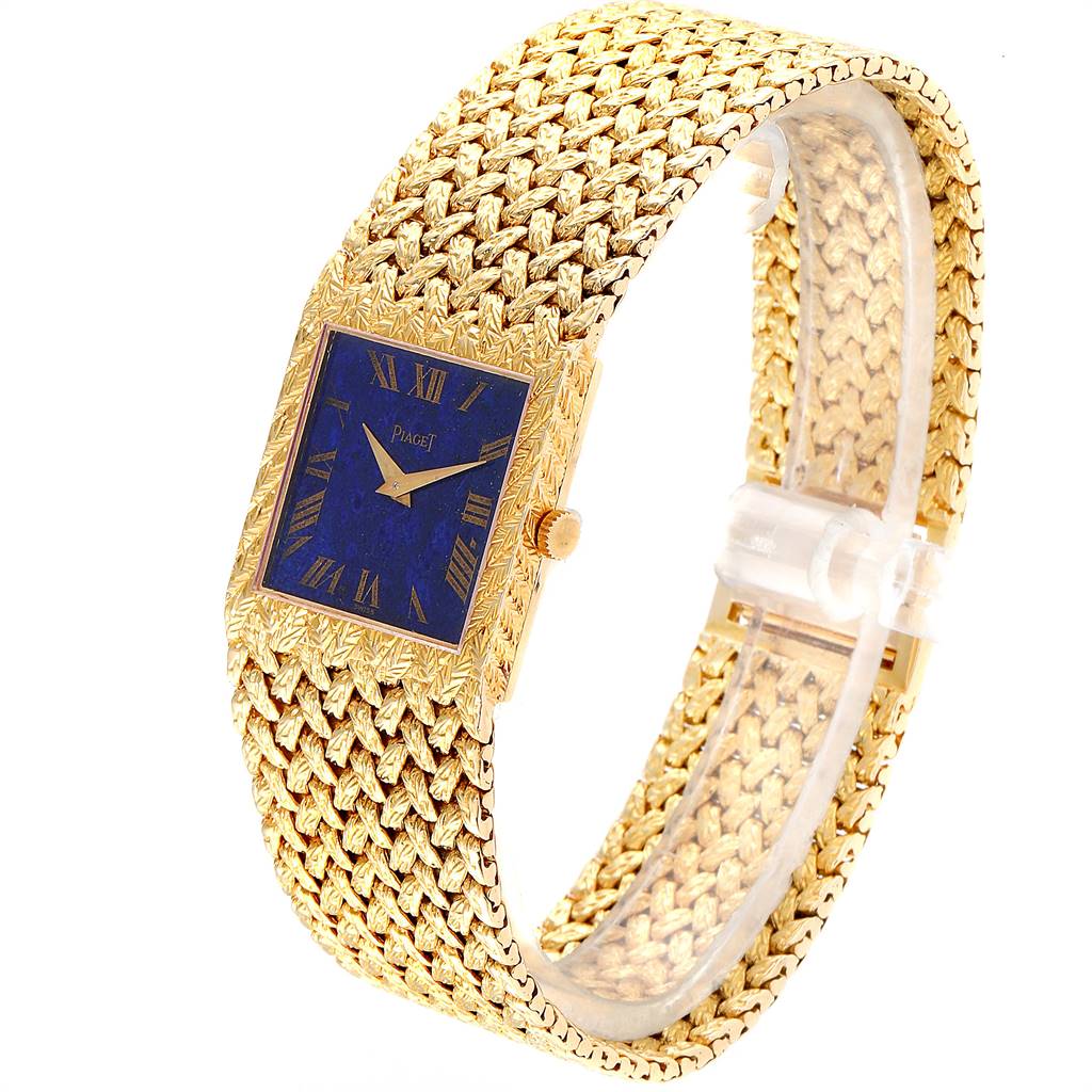 The photo shows a side angle of the 18k Yellow Gold Piaget 9352 Men's Yellow Gold Blue Dial 9352 Men's Yellow Gold Blue Dial 9352 Vintage Men's Watch with a Blue Lapis Lazuli Dial and detailed gold band.