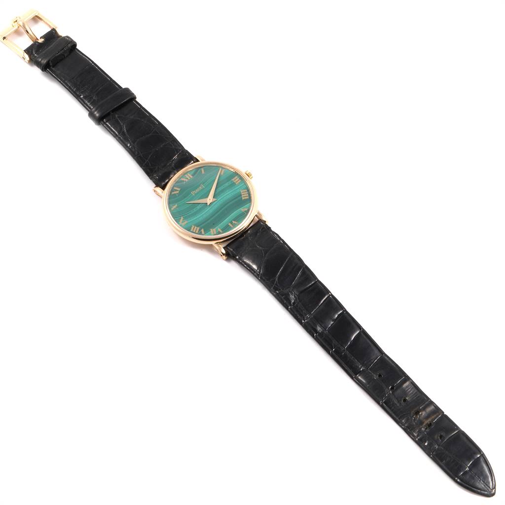 This image shows a top view of the Piaget 9015 Women's Yellow Gold Green Dial 9015 Women's Yellow Gold Green Dial 9015 Yellow Gold Malachite Dial Vintage Ladies Watch with a black leather strap.