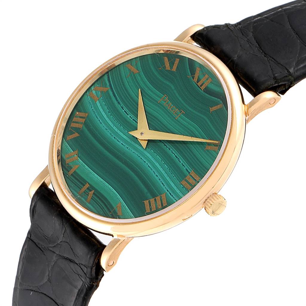 The Piaget 9015 Women's Yellow Gold Green Dial 9015 Women's Yellow Gold Green Dial 9015 model watch is shown at an angled close-up, displaying the dial, gold casing, and part of the black strap.
